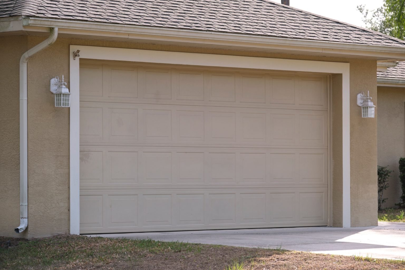 wide-garage-double-door-and-concrete-driveway-of-new-modern-american-house-1-1536x1024-1