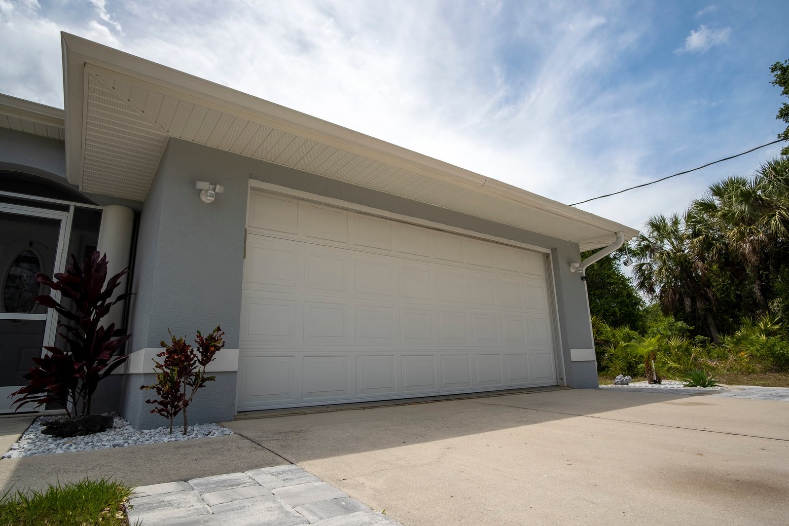 wide-garage-double-door-and-concrete-driveway-of-new-modern-american-house-2 (1)